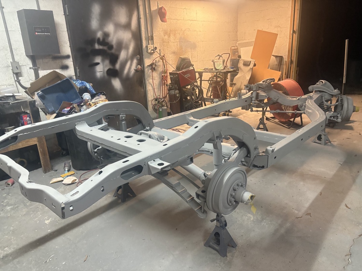 Rusty automotive frame being blasted back to bare metal on-site