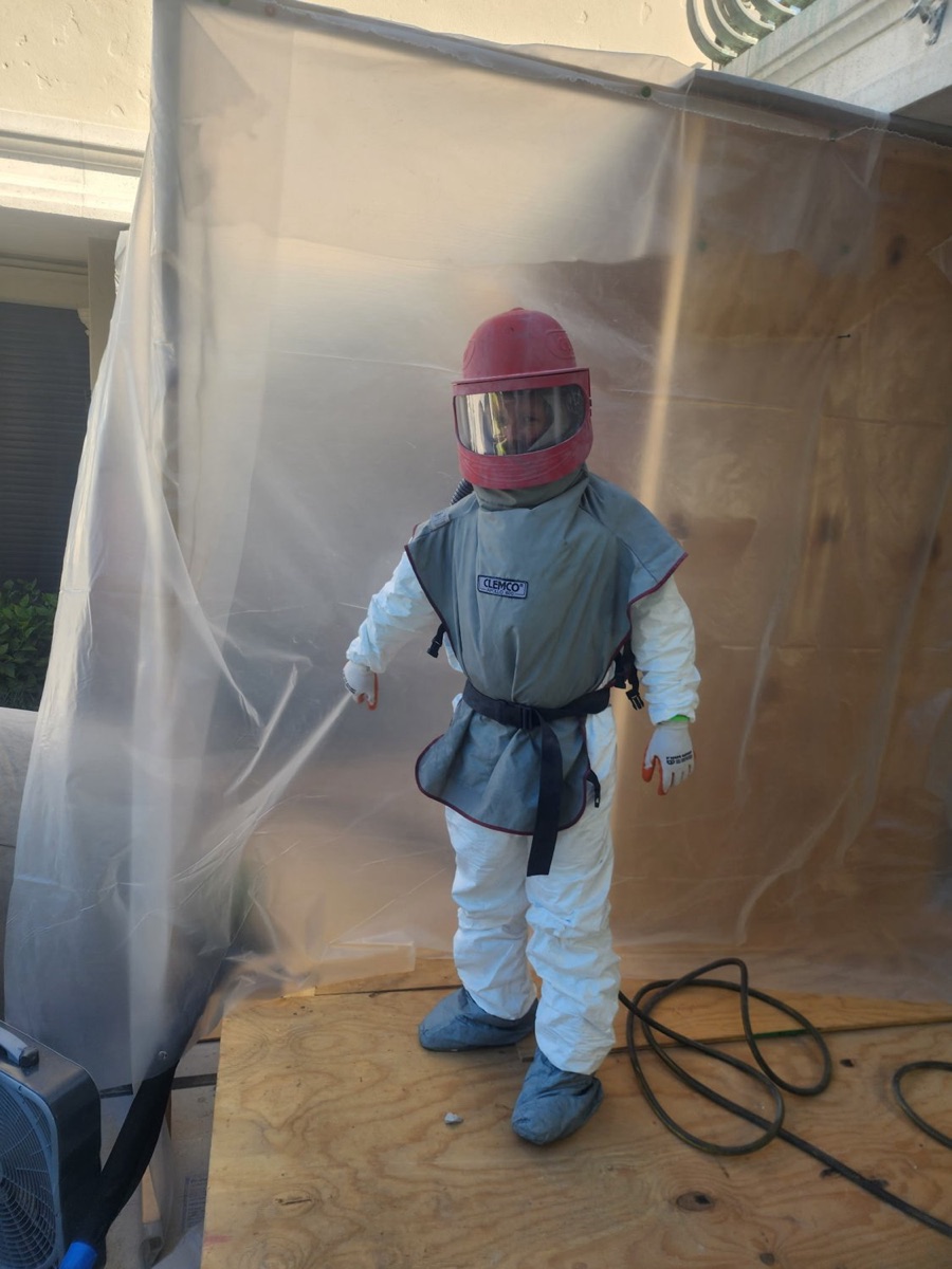 Media blasting stripping a surface to a clean profile in a contained work area