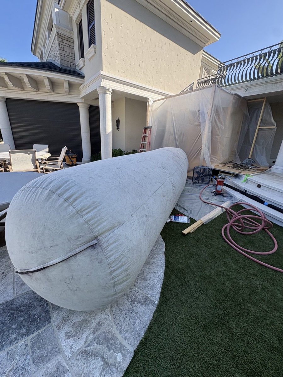 Boat masked and draped for contained mobile bottom paint blasting in Southwest Florida