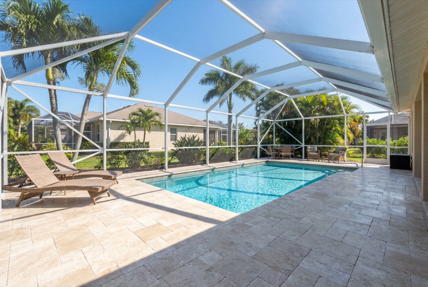Restored paver pool deck and lanai at a Cape Coral waterfront home after sealer removal
